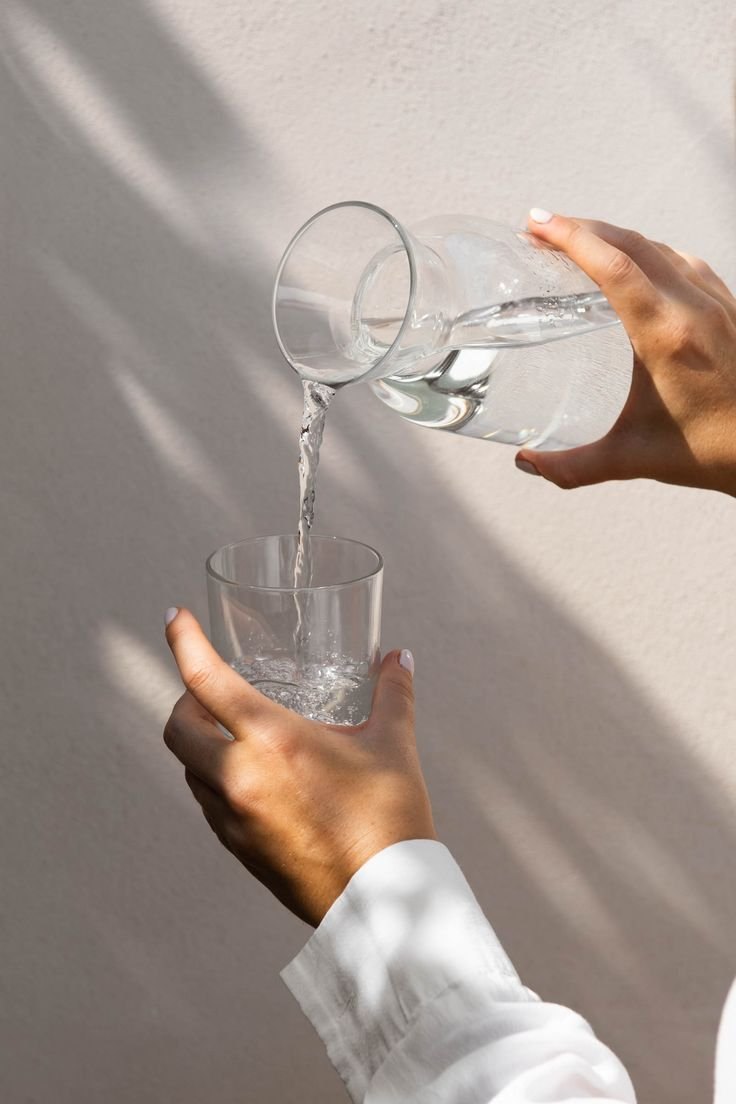 Water poured into a glass in the sun